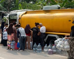 Warga antre mengambil bantuan air bersih untuk memenuhi kebutuhan sehari-hari di tengah musim kemarau di Kecamatan Babakan Madang, Kabupaten Bogor.